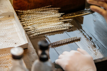 Ponikla, Czech Republic, 31 December 2021: Glass bead vintage ornaments and figurines hand-manufacturing, traditional production of Christmas and New Year decorations, hand painted, silver plating