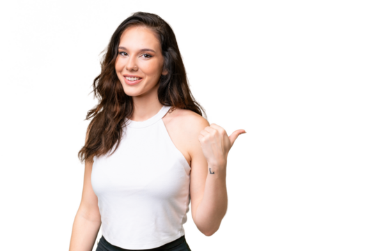 Young caucasian woman isolated over isolated background pointing to the side to present a product