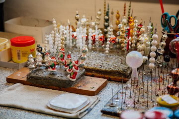 Ponikla, Czech Republic, 31 December 2021: Glass bead vintage ornaments and figurines hand-manufacturing, traditional production of Christmas and New Year decorations, decorative hand painted