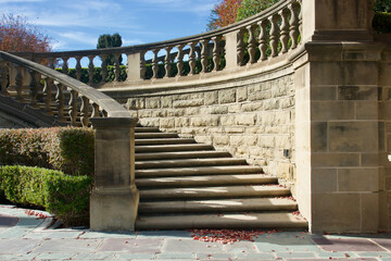 balustrade lined grand staircase with steps curving down to the terrace