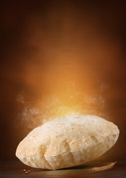 Indian Traditional Cuisine Chapati The Phooli (Air filled) Roti, Fulka flying, Indian Bread, Flatbread, Whole Wheat Flat Bread, Chapati. On dark textured background.