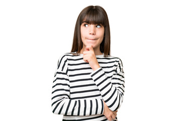 Little caucasian girl over isolated background having doubts and thinking