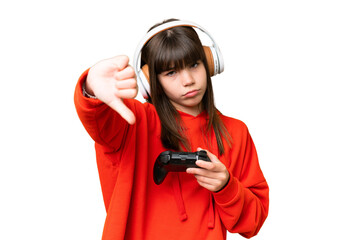 Little caucasian girl playing with a video game controller over isolated background showing thumb...