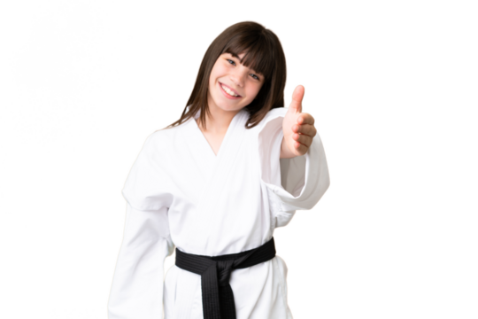 Little Caucasian girl doing karate over isolated background shaking hands for closing a good deal