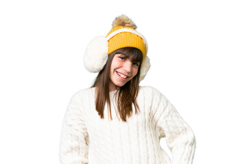 Little caucasian girl wearing winter muffs over isolated background laughing