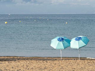 Two lonely umbrellas on the beach