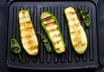 Grilled zucchini, pepper and carrots. Cooking delicious food at home on electric grill. Close-up