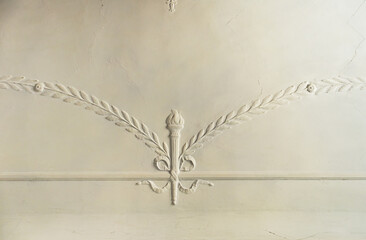 Gypsum molding pattern on the ceiling. Decorative gypsum finish in an old house