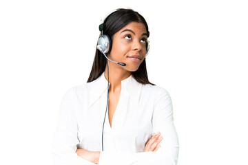 Telemarketer African American woman working with a headset over isolated chroma key background making doubts gesture while lifting the shoulders