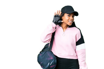Young sport African American woman with sport bag over isolated chroma key background listening to something by putting hand on the ear
