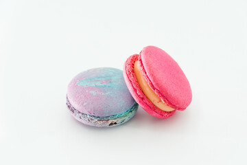 Sweet colorful macarons isolated on white background. Tasty colourful macaroons. Two multi-colored blue and pink macaroons. French pastry made from egg whites.