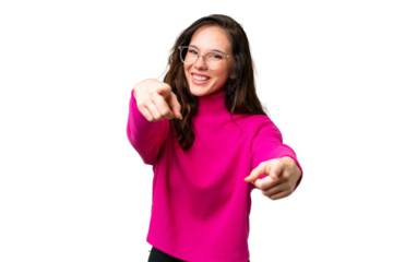 Young caucasian woman isolated over isolated background points finger at you while smiling