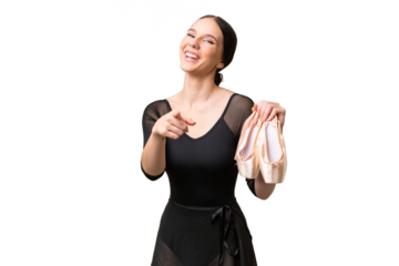 Young caucasian woman practicing ballet over isolated background pointing front with happy expression