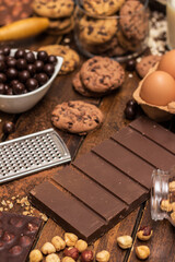 Ingredients for preparing and baking cookies. Ingredients includes are flour, eggs, chocolates, chocolate chips, sugar,  milk,  butter, and equipment