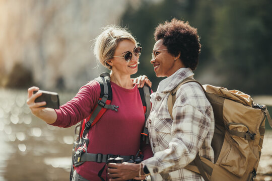 Two Women Taking Selfie While Hike - Powered by Adobe