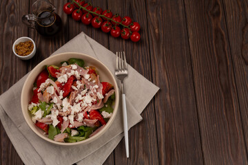 Mix of lettuce leaves with smoked chicken meat, tomatoes and salted soft cheese, with mustard-lemon dressing