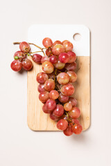 Red grapes on wooden board