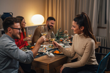 Two friends having a toast on a dinner party