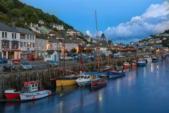 LOOE, CORNWALL - JUNE 06, 2009: The harbour and town at night with lights reflected in the water