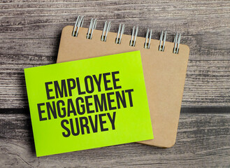 Employee Engagement Survey. Text on green business card with pen
