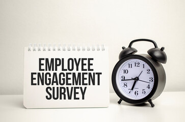 Employee Engagement Survey words with calculator and clock with notebook