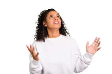 Young Brazilian curly hair cute woman isolated screaming to the sky, looking up, frustrated.