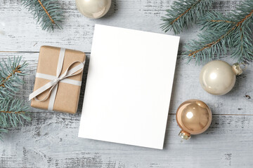 Blank Christmas or New Year greeting card mockup with gift box