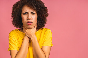 Fototapeta na wymiar African american woman with afro hair wearingcasual feeling unwell and coughing as symptom for cold or bronchitis. Health care concept isolated over pink background.