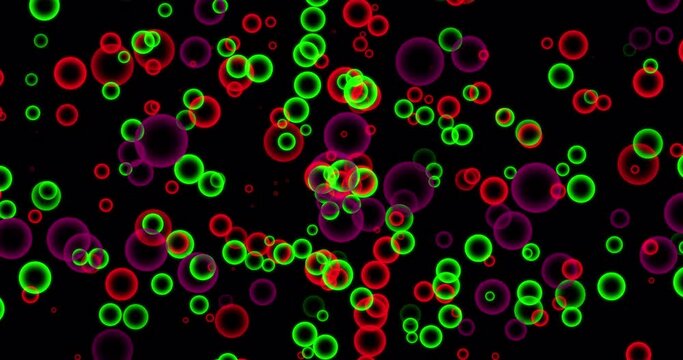 Motion red and green round on black. High quality stock footage and visuals featuring red and green bokeh orb shaped particle motion backgrounds.