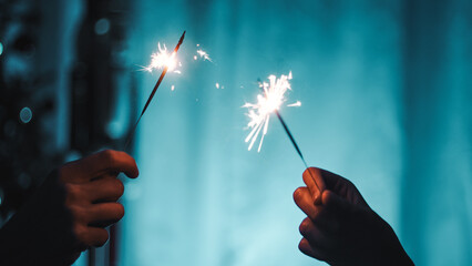 Sparklers on blue background. Happy new year,