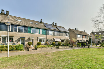 Exterior of residential houses surrounded with green plants in daytime