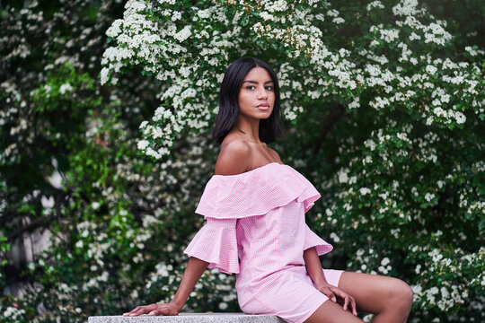 black woman near blooming tree