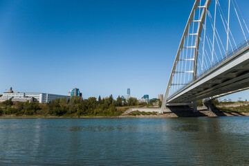 Modern arc bridge over the river,  day traffic, summer time. modern architecture, panorama of the city Edmonton