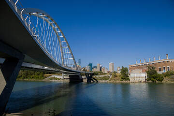 Modern arc bridge over the river,  day traffic, summer time. modern architecture, panorama of the city Edmonton