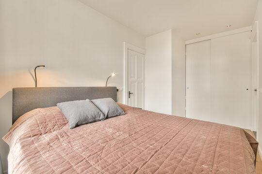 Soft bed and nightstand in modern light bedroom