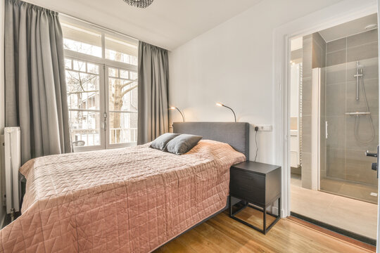 Soft bed and nightstand in modern light bedroom