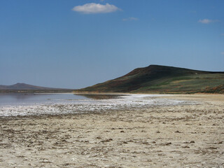 Landscape, a salt lake illuminated by the sun against a clear, cloudless sky. Wildlife, the concept of tourism, recreation and travel.