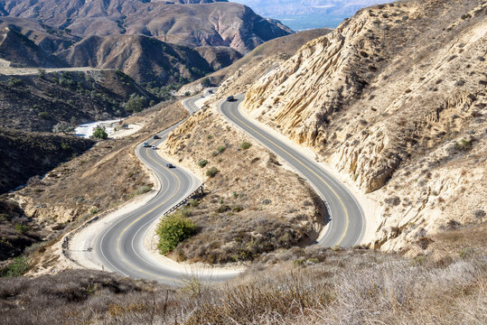 View of winding canyon road on a sunny autumn day
