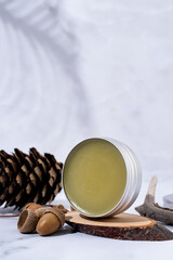 colorful lip balms in round tin cases on podium with shadow overlay, mockup design