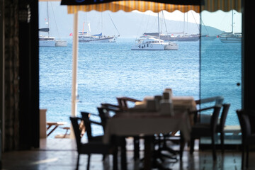 Restaurant near the sea with a view of the ships and mountains