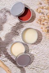colorful lip balms in round tin cases with shadow overlay, mockup design