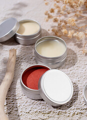 colorful lip balms in round tin cases with shadow overlay, mockup design
