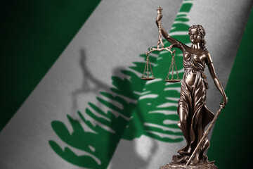 Norfolk island flag with statue of lady justice and judicial scales in dark room. Concept of...