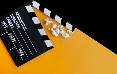 
stylish mockup with clapperboard in black and orange colors. copy space, space for text. top view. flat lay style. concept cinema party, film industry, movie premiere