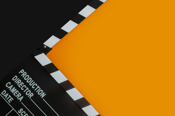 
stylish mockup with clapperboard in black and orange colors. copy space, space for text. top view....