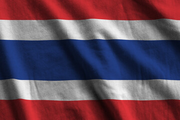 Thailand flag with big folds waving close up under the studio light indoors. The official symbols...