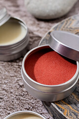 colorful lip balms in round tin cases with shadow overlay, mockup design