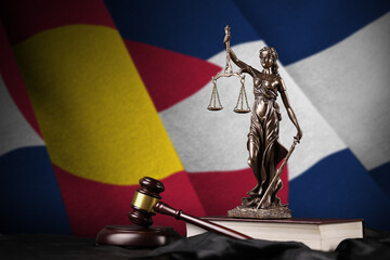 Colorado US state flag with statue of lady justice, constitution and judge hammer on black drapery....