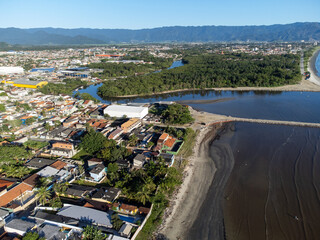Fototapeta na wymiar quiet beach with flowing river and small coastal town
