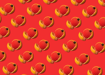 Creative pattern of Christmas decoration for the New Year tree, red Christmas ball inside a grapefruit on a red background. Minimal red christmas background.